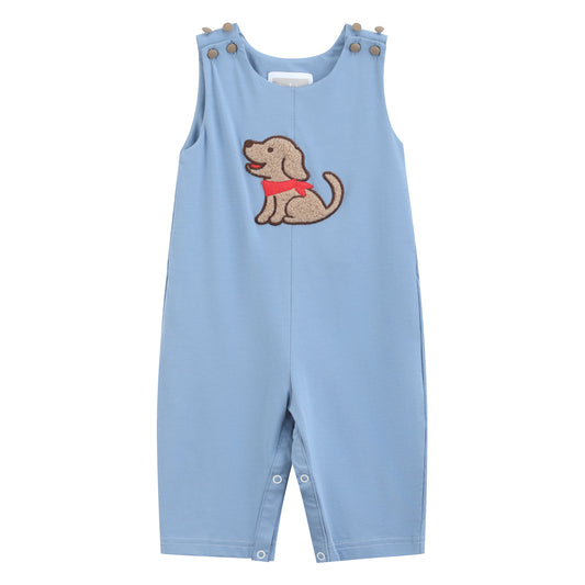 A light blue sleeveless baby romper with an embroidered brown dog wearing a red collar on the chest, featuring snap closures at the shoulder straps and crotch.